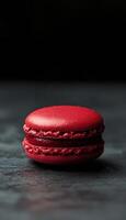 A red macaron on a black surface photo