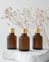 Three small bottles of essential oils sitting on a white surface photo