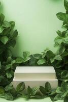 Green mint leaves and a white box on a green background photo