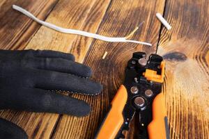 Mechanical stripper for stripping electrical cable insulation. An electrician's tool. Expose the wires photo