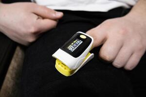 Pulse oximeter used to measure pulse rate and oxygen levels at home photo