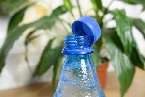 Stationary plastic cap on a PET bottle. The new design means the cap remains attached to the bottle after opening, making the entire package easier to collect and recycle photo