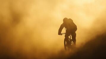 Silhouette Cyclist Mountain Biking in Golden Sunset Haze photo