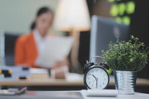 A woman is working on her laptop in the background photo