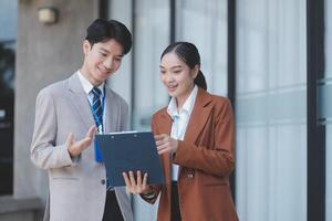 Asian business couple holding a folder photo
