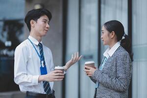 A man and woman in business attire talking photo