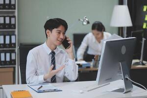 A man in a business suit talking on the phone photo
