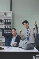Two asian businessmen sitting at a table photo