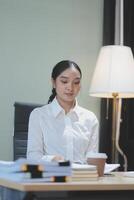A woman sitting at a desk photo