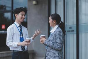 Two young people talking outside an office building photo