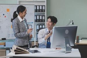 A man and woman in an office talking to each other photo