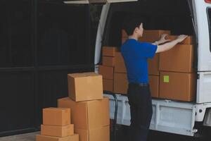 A man loading boxes into a van photo
