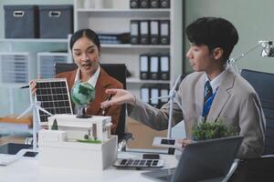 Two people in business attire working on a laptop photo
