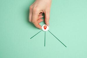 Hand with geolocation icon and new directions for next destinations. Navigation, exploring new destinations, planning travel routes. GPS services, mapping travel guidance photo