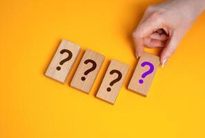 The hand selects unknown options from those presented. Quiz. Unknown prizes and promotion. Secrets and mysteries. Surprise rewards, prize draws, or hidden outcomes in contests. photo