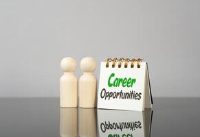 Career opportunities on a notebook and figures of people. New steps to advancement. Career plans photo