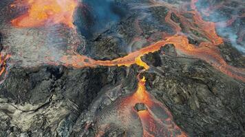 an aerial view of lava flowing into the ocean video
