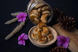 High angle view product photography of Peanut cookies, a type of dry cookie made from peanuts in various shapes, usually served on holidays, such as Eid al-Fitr, Christmas, and Chinese New Year. photo