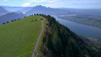 aerial view of a mountain top with a path leading to a lake video