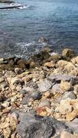 Island shore of large cobbles and rocks, raging ocean waves video