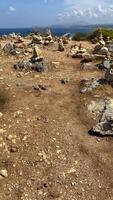 Stony desert terrain on an island, rocks lying on top of each other in the form of a pyramid video