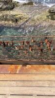 Old locks hanging on the bridge, sea and beach under the bridge video