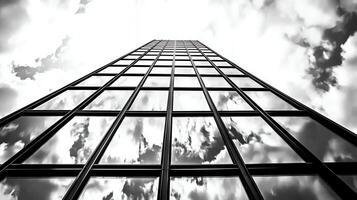 Tall Glass Facade Building Reflecting Clouds Under Dramatic Sky photo