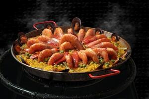 Shrimp Paella Valenciana being prepared in the paellera photo
