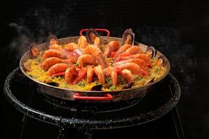Valencian shrimp paella in the pan with rice photo