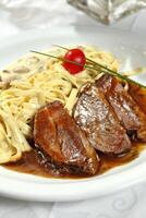 Fettuccine with meat in Roti sauce photo