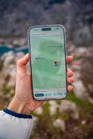 Kotor, Montenegro - January 2.2025. Close-up of a hand holding iPhone displaying Google Maps, symbolizing modern navigation and digital wayfinding, mobile technology and real-time location services. photo