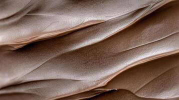 Rich brown paint texture with smooth, flowing layers and warm tones photo