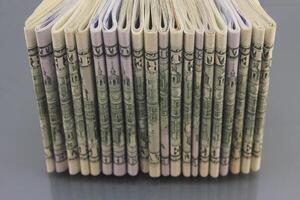 Stacks of American money, hundred dollar bills in cash on a dark background, many hundred dollar bills photo