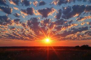 Sunset over a Field with a Glowing Sky and Sun Rays photo