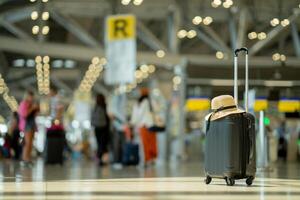 The suitcases in an empty airport hall, traveler cases in the departure airport terminal waiting for the area, vacation concept, blank space for text message or design, luggage for travel. photo
