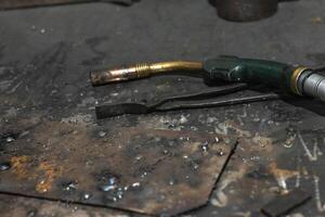 Part of welding machine on workbench in workshop photo