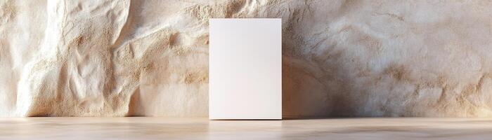 A blank business card stands upright and slightly leans against a neutral-toned wall. The soft focus enhances the aesthetic, creating a professional ambiance ideal for luxury branding photo