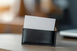 A blank business card is partially tucked into a luxurious leather cardholder, illuminated by soft lighting that enhances the fine-grain texture photo