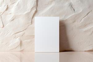 A minimalistic blank business card stands upright, leaning slightly against a softly textured wall. The background blurs gently, creating a luxurious and professional atmosphere ideal for branding photo