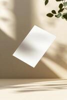A blank business card hovers in midair, casting a gentle shadow below. The background is a smooth gradient with soft focus, emphasizing a sleek and modern aesthetic ideal for branding photo
