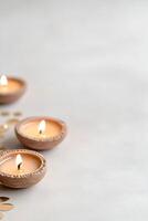 Bottom border adorned with traditional Diwali diyas casting a warm light, complemented by intricate Rangoli patterns on a subtly neutral backdrop, ideal for festive themes photo