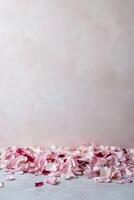 Scattered rose petals in shades of pink and red create an elegant, dreamy atmosphere against a soft, blurred pastel background, ideal for wedding or Valentine's Day designs photo
