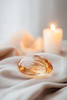 Amber gemstone glows warmly, resting on a soft velvet surface as candlelight flickers nearby. The cozy atmosphere and blurred background create an inviting and elegant setting perfect for branding photo