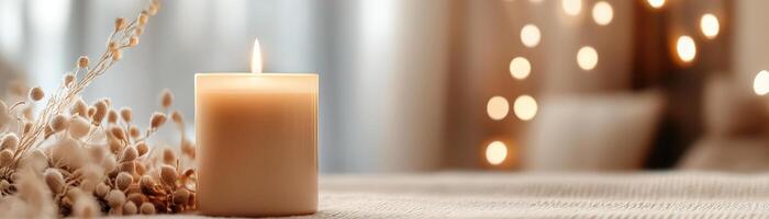 Warm glow of an amber candle illuminates a dimly lit room, casting soft light on neutral tones, inviting relaxation and calm. Perfect for spa settings or home decor photo