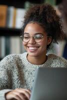 A smiling tutor assists a student through an online lesson at her desk, with an open laptop in front of her photo