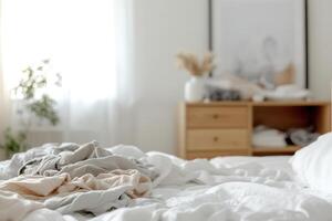 A bedroom shows signs of disarray with an unmade bed and clothes strewn across the floor, creating a lived-in feel. The clutter adds to the authentic charm of space, suggesting a need for tidying photo