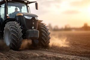 A large tractor moves steadily across an open field, generating clouds of dust as the warm sunlight casts a golden hue. This captures the essence of hard work in modern agriculture photo