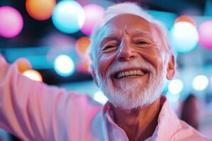 An elderly man with a joyful expression dances energetically under colorful disco lights. His big smile radiates happiness, capturing the lively spirit of an engaging social event photo