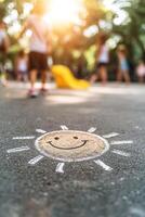 A cheerful chalk drawing of a smiling sun adorns the concrete of a school playground. Children play joyfully in the soft afternoon light, creating a nostalgic atmosphere photo