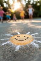 A cheerful chalk drawing of a smiling sun brightens the concrete floor of a school playground. In the background, children play joyfully on a warm afternoon, creating a nostalgic atmosphere photo